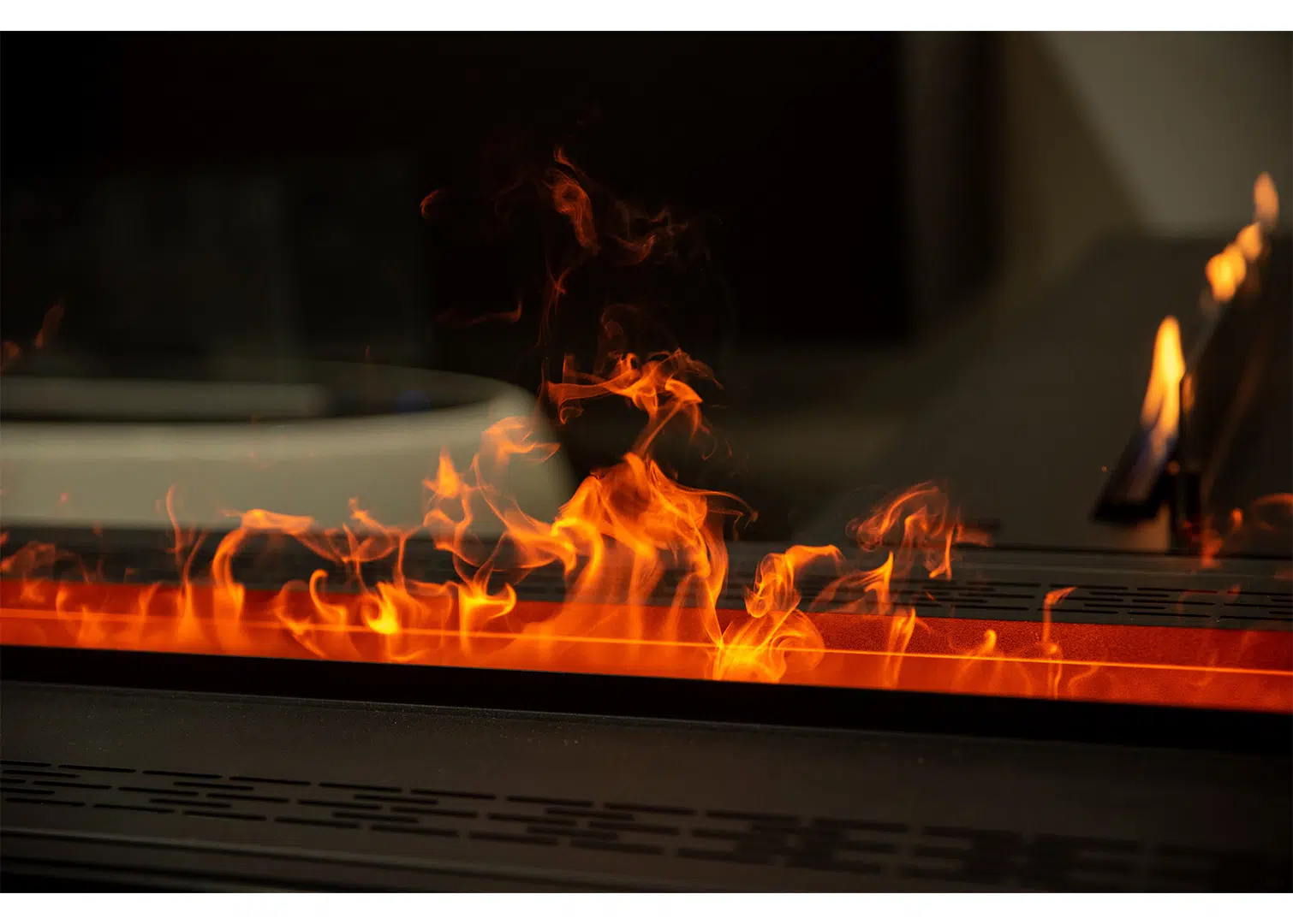 A tight shot on a gas fireplace with flames rising out of the firebox.