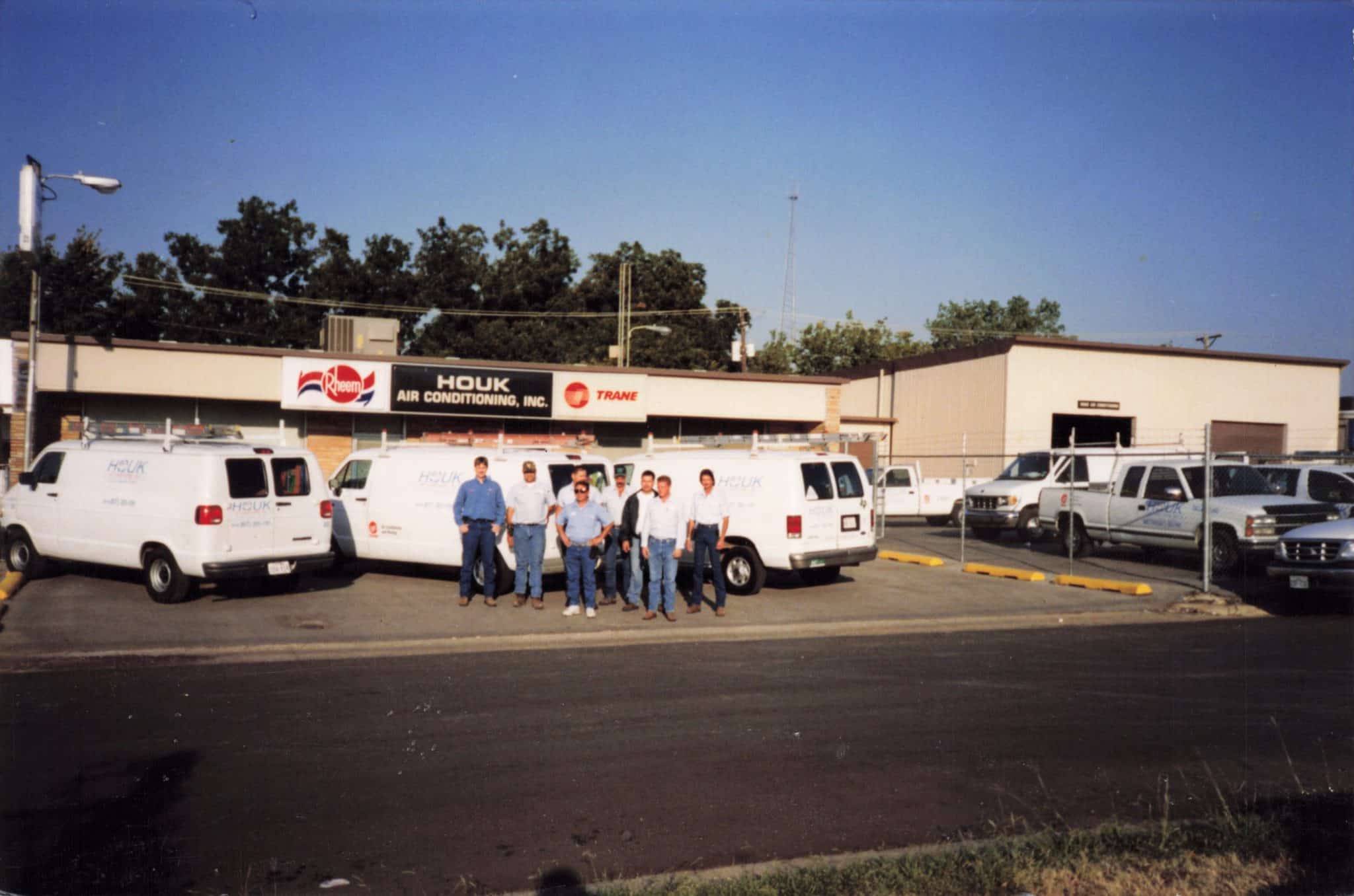 Historic Houk Air Conditioning storefront and service vehicles in Dallas-Fort Worth.