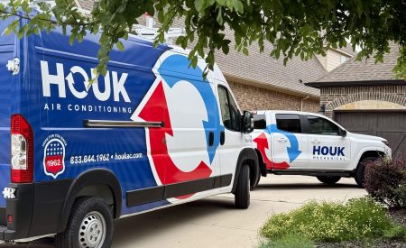 Houk AC service vehicles outside Dallas-Fort Worth home during a Helping Hands HVAC installation.