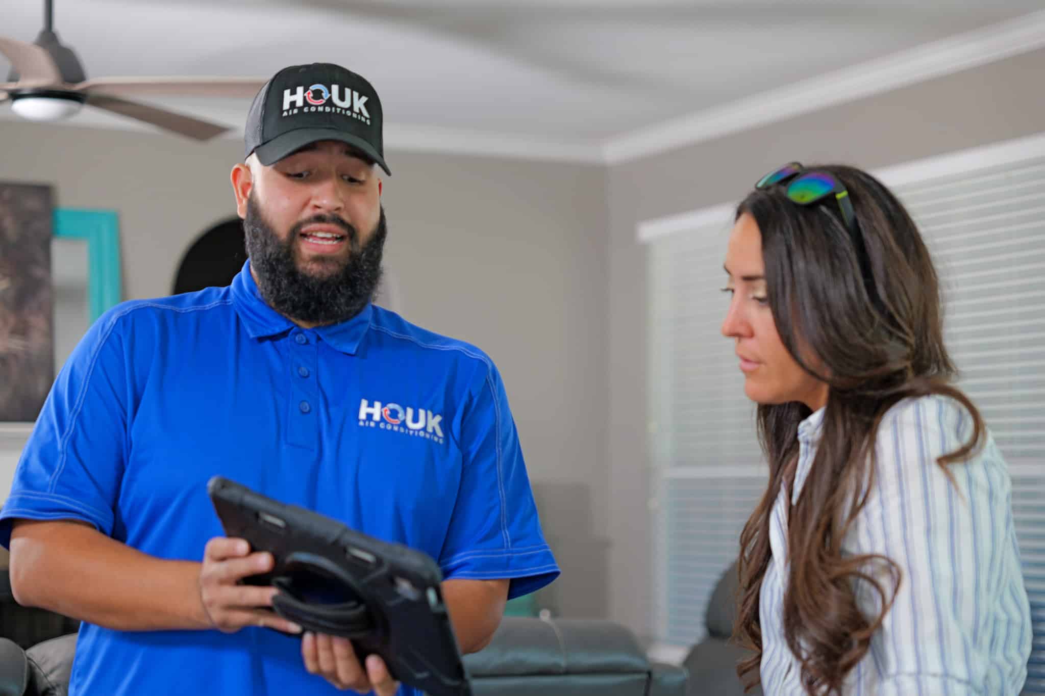 Houk AC technician talks with a homeowner about the helping hands program