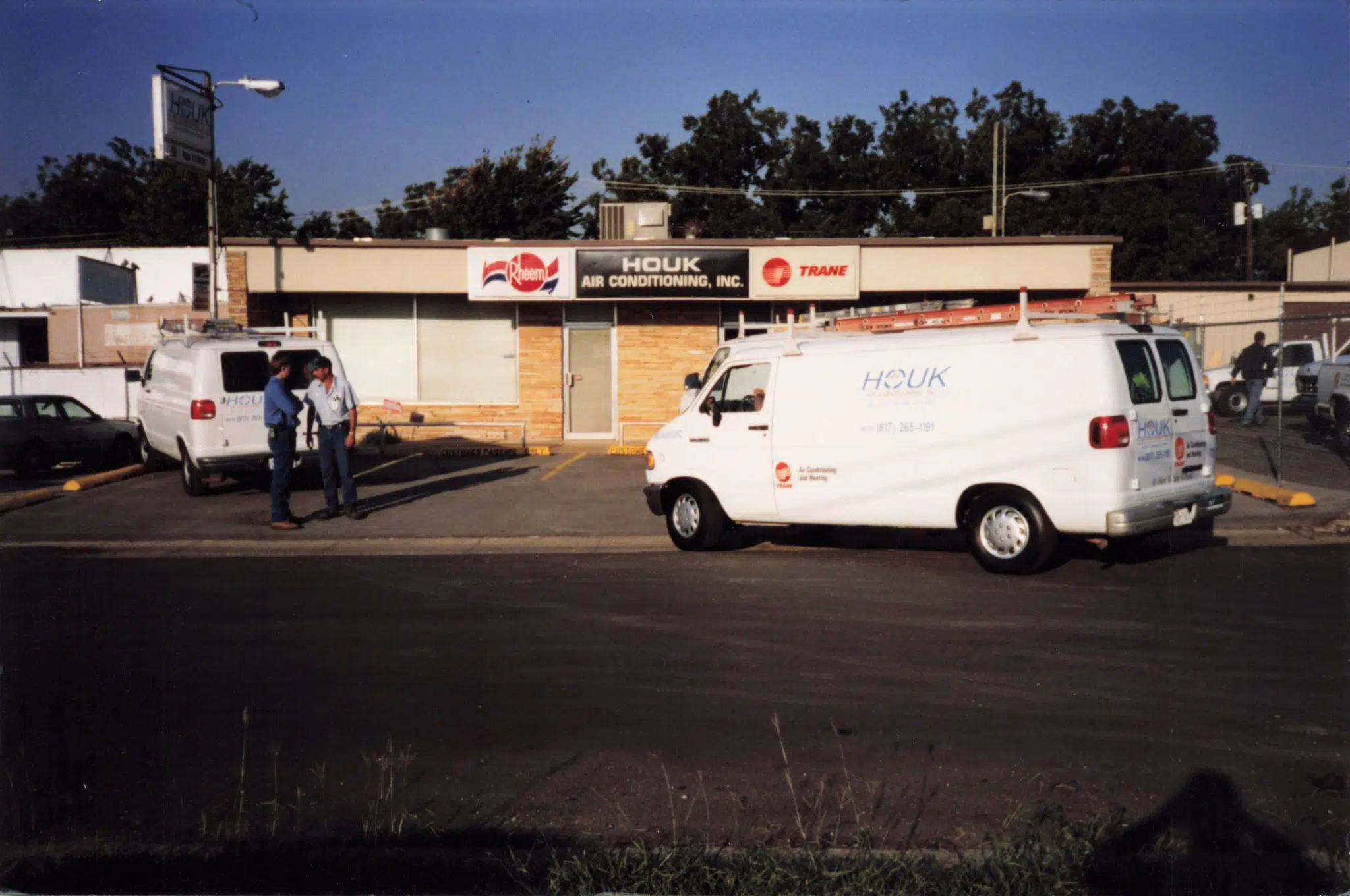 Houk AC service vans parked outside the company’s historic air conditioning office in North Texas.