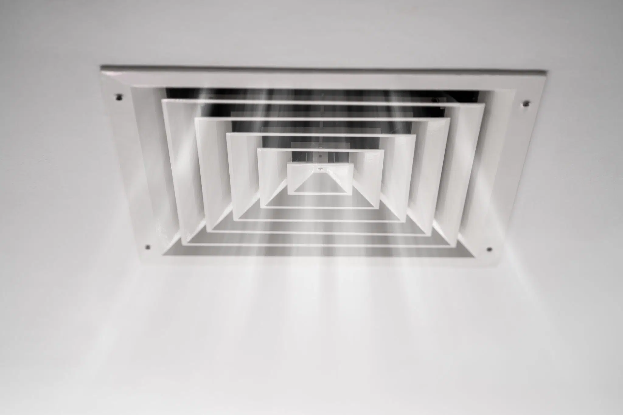Indoor air vent circulating air through an HVAC system during indoor allergies in spring.