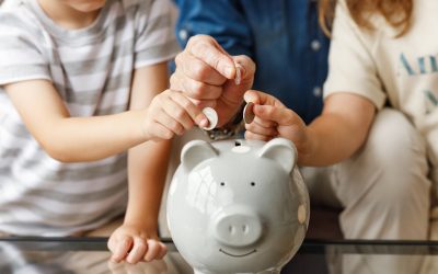 Children and a parent saving coins in a piggy bank, a nod to the money DFW homeowners keep with smart HVAC maintenance tips.