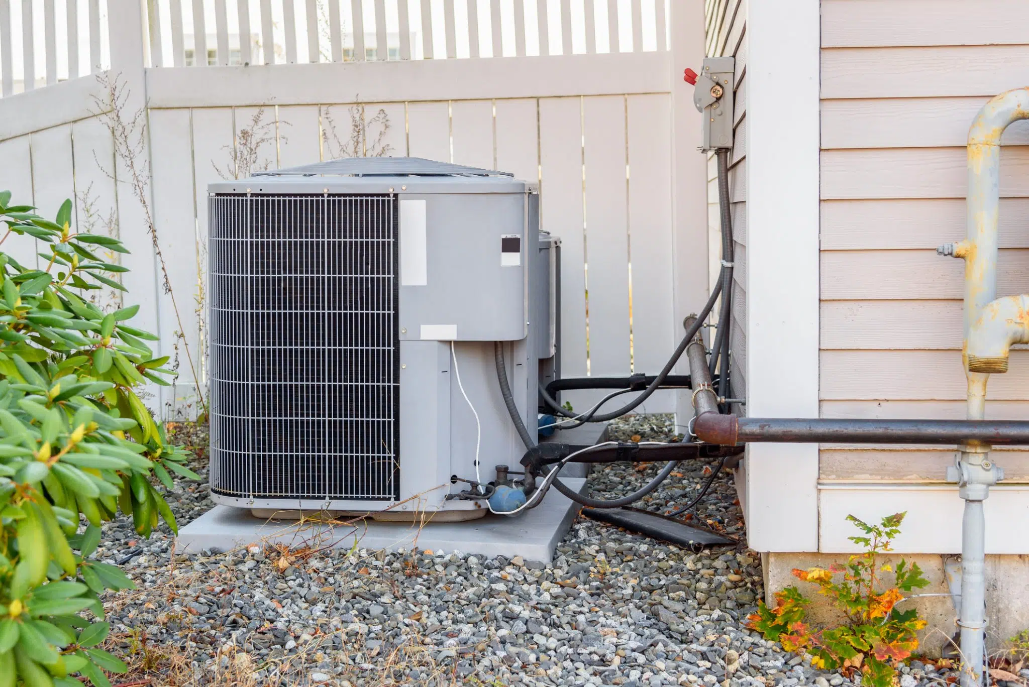 A standard AC unit showing wear, a sign it's ready for a high-efficiency replacement.