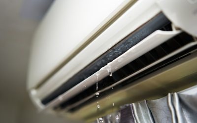 Water leaking from an indoor AC unit vent, a sign of water around an AC unit that needs attention.