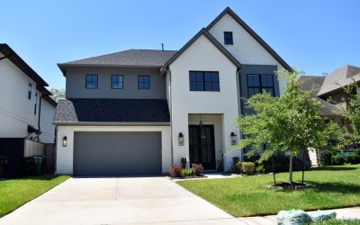 Two-story new build with white brick and gray siding, typical of new construction HVAC homes in Frisco and North Dallas.