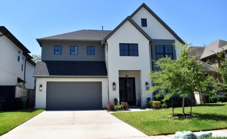 Two-story new build with white brick and gray siding, typical of new construction HVAC homes in Frisco and North Dallas.